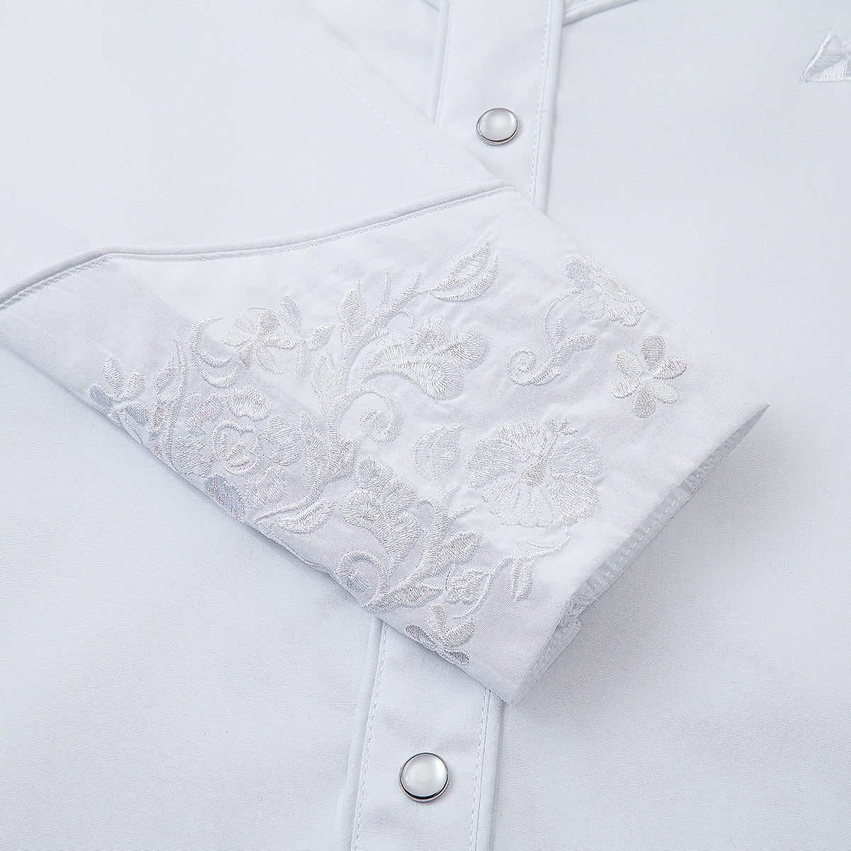 White floral embroidered men's western pearl snap shirt - cuff and snaps detail