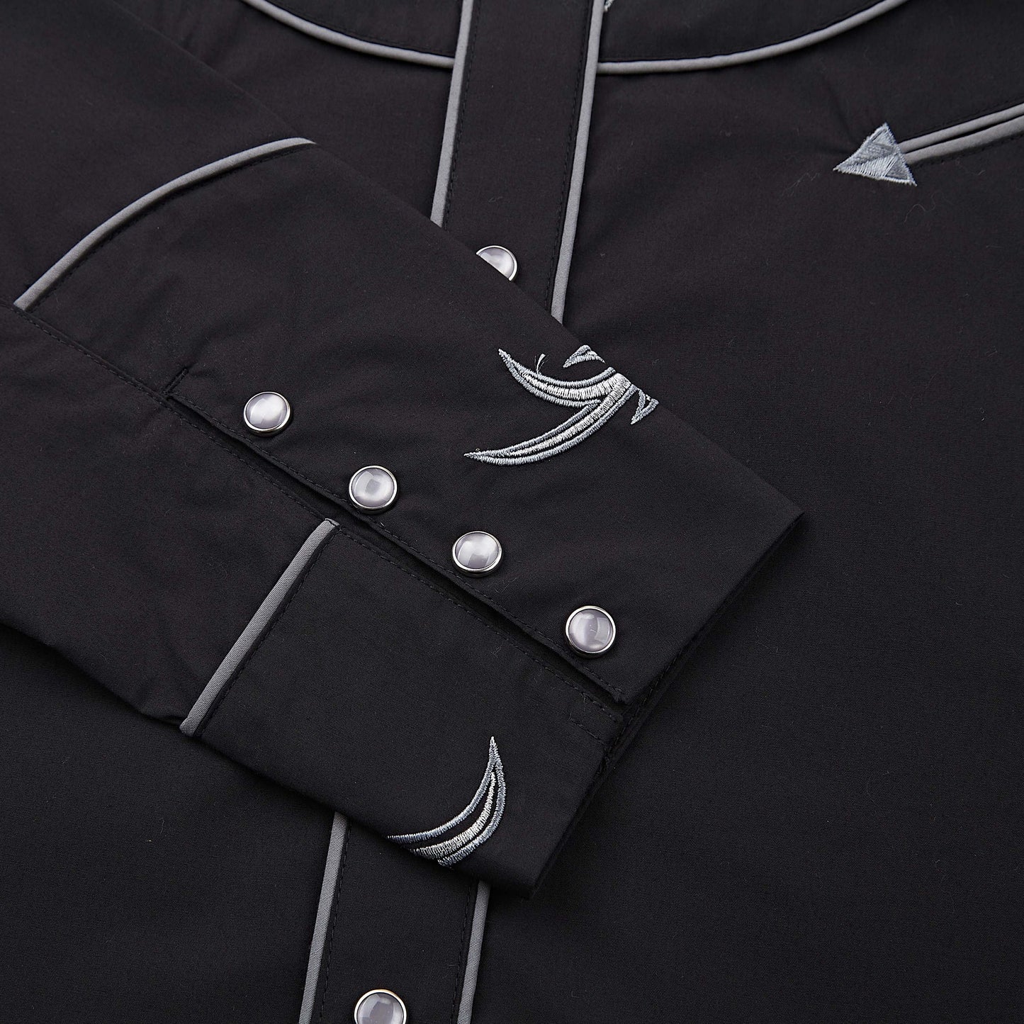 Black and silver longhorn skull embroidered men's western pearl snap shirt - cuff and pearl snaps close-up