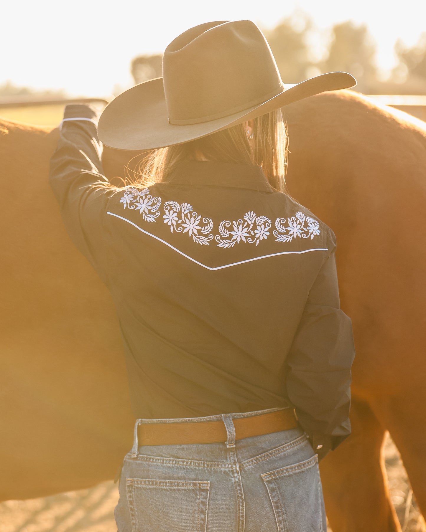 Black and white floral embroidered women's western pearl snap shirt - cowgirl styled look, back