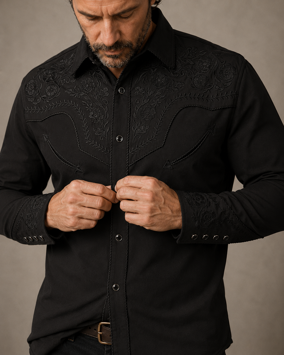Black floral embroidered men's western pearl snap shirt - pearl snap buttoning detail on model