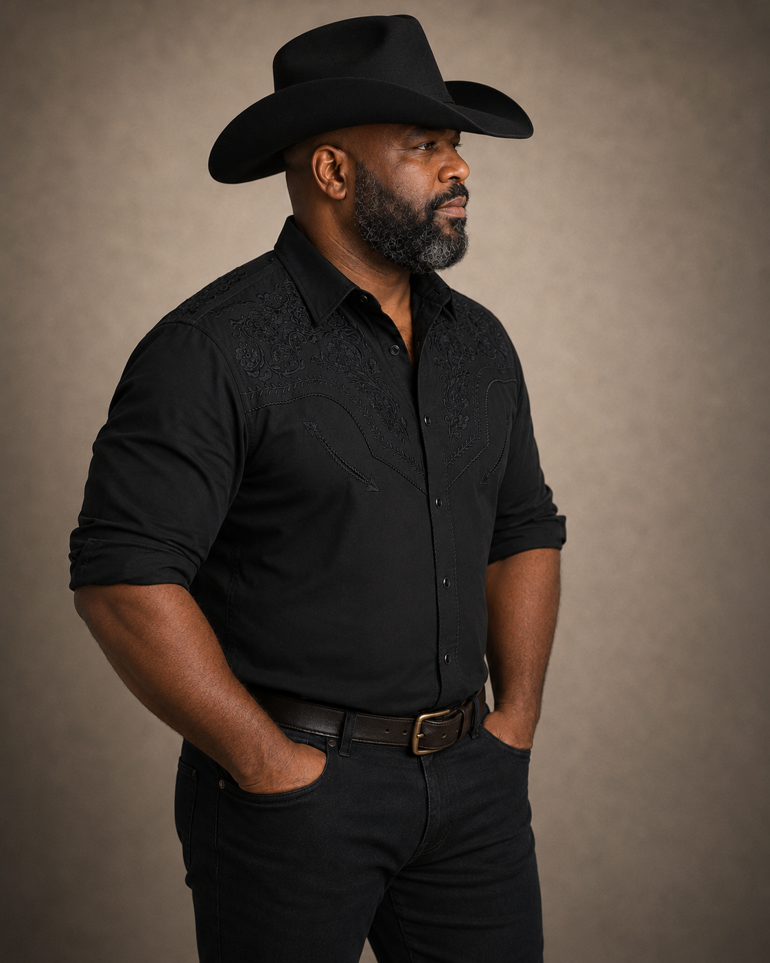 Black floral embroidered men's western pearl snap shirt - side profile on model