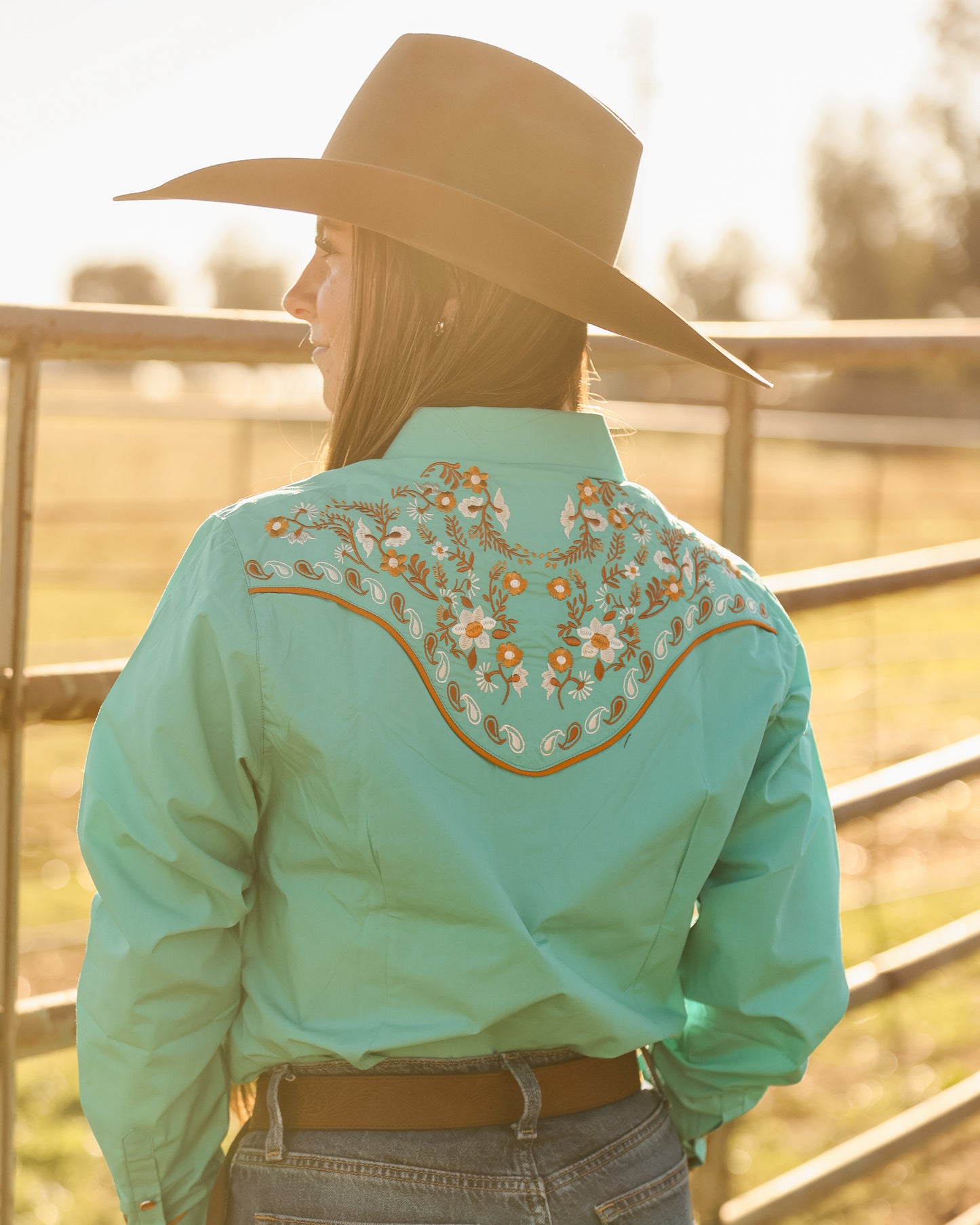 Blue and green floral embroidered women's western pearl snap shirt - cowgirl styled look, back
