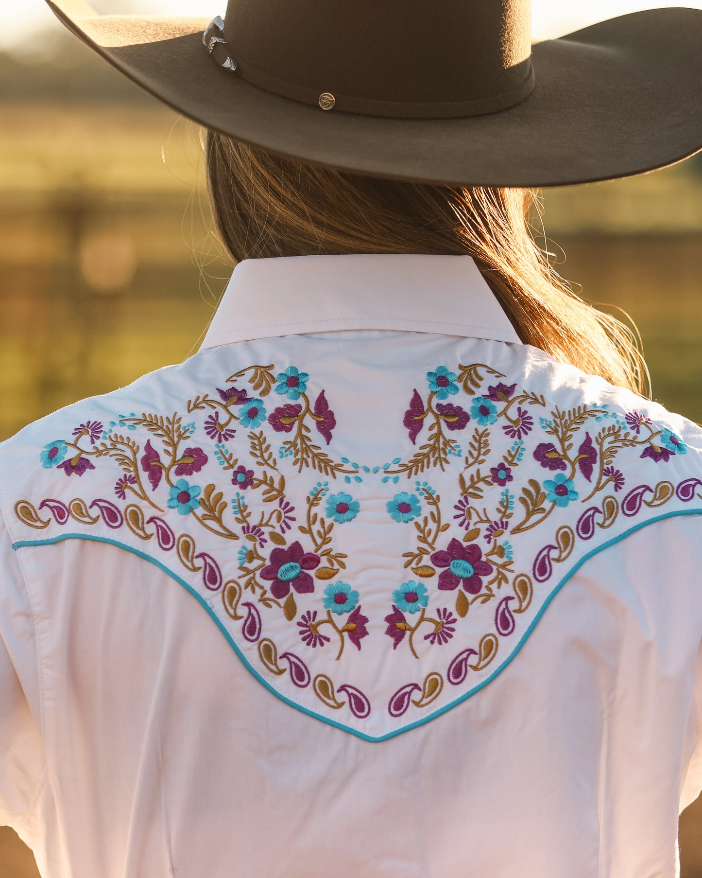 White floral embroidered women's western pearl snap shirt - cowgirl styled look, back